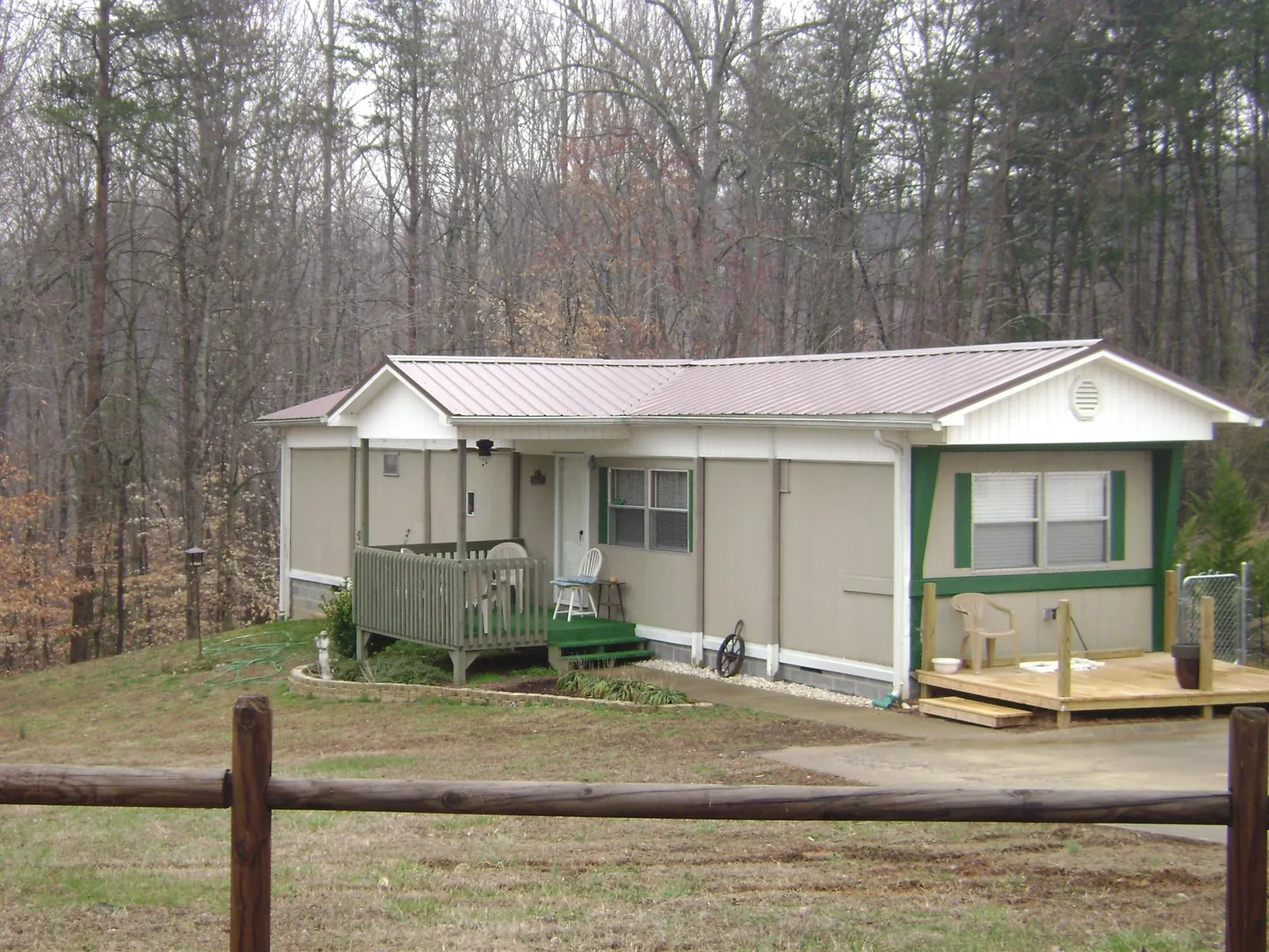 Mauve metal roof on a manufactured home with a new front deck in Mooresville